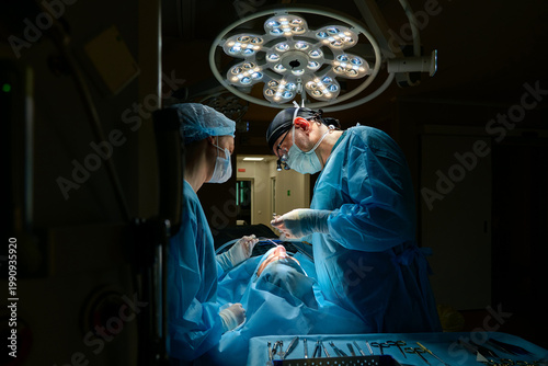 plastic surgeon performs surgery in the operating room