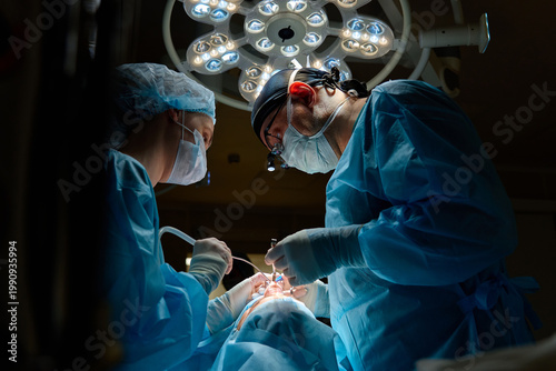 plastic surgeon performs surgery in the operating room