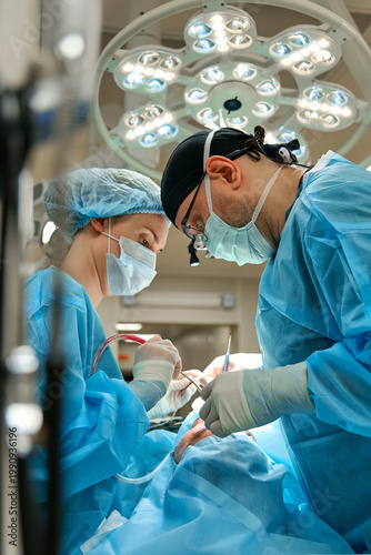 plastic surgeon performs surgery in the operating room