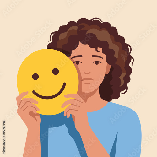 A contemplative woman is shown holding a smiling face mask while appearing sad, representing the complex nature of emotions and the struggle to maintain positivity within oneself.