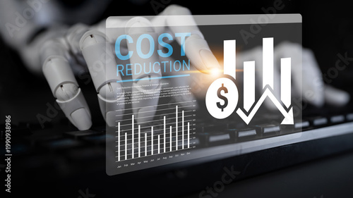 Photos A robotic hand interacts with a keyboard, accompanied by graphical representations of financial data and cost reduction trends, symbolizing modern technology in business