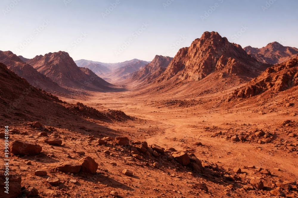 Obraz premium Dry Martian terrain featuring rugged mountains under a clear sky