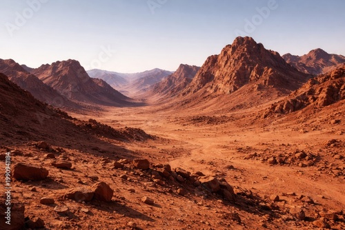 Dry Martian terrain featuring rugged mountains under a clear sky