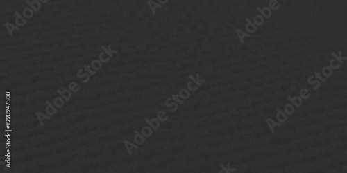 Dark macro skin and rough cloth material create a textured black leather and fabric background with a grey fiber pattern on the surface