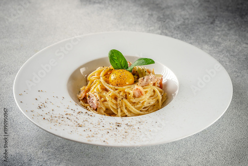 Spaghetti carbonara with egg yolk and bacon