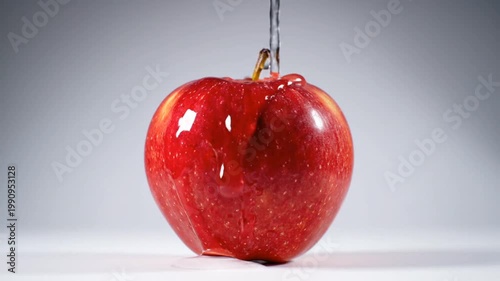 Fresh red apple with clean water pouring over it