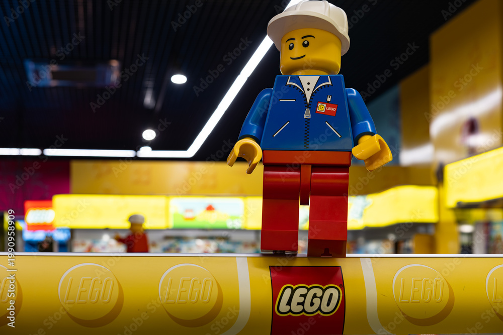 Fototapeta premium LEGO worker minifigure on yellow display shelf in store