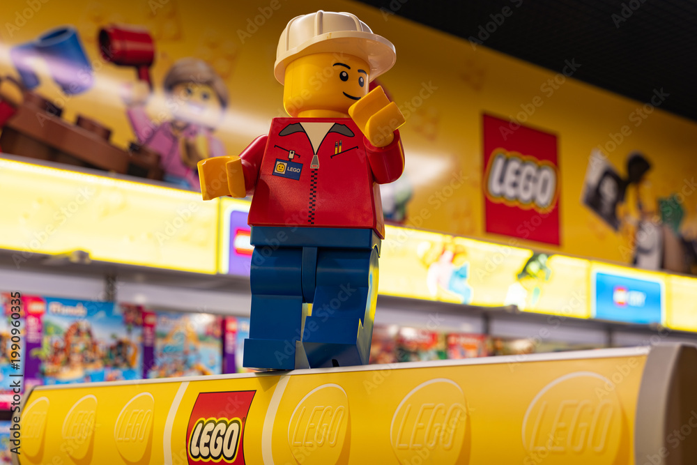 Fototapeta premium LEGO worker minifigure on yellow display shelf in store
