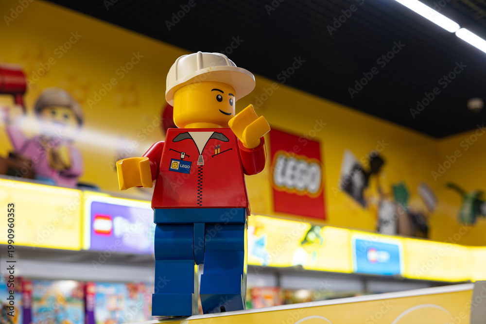 Fototapeta premium LEGO worker minifigure on yellow display shelf in store