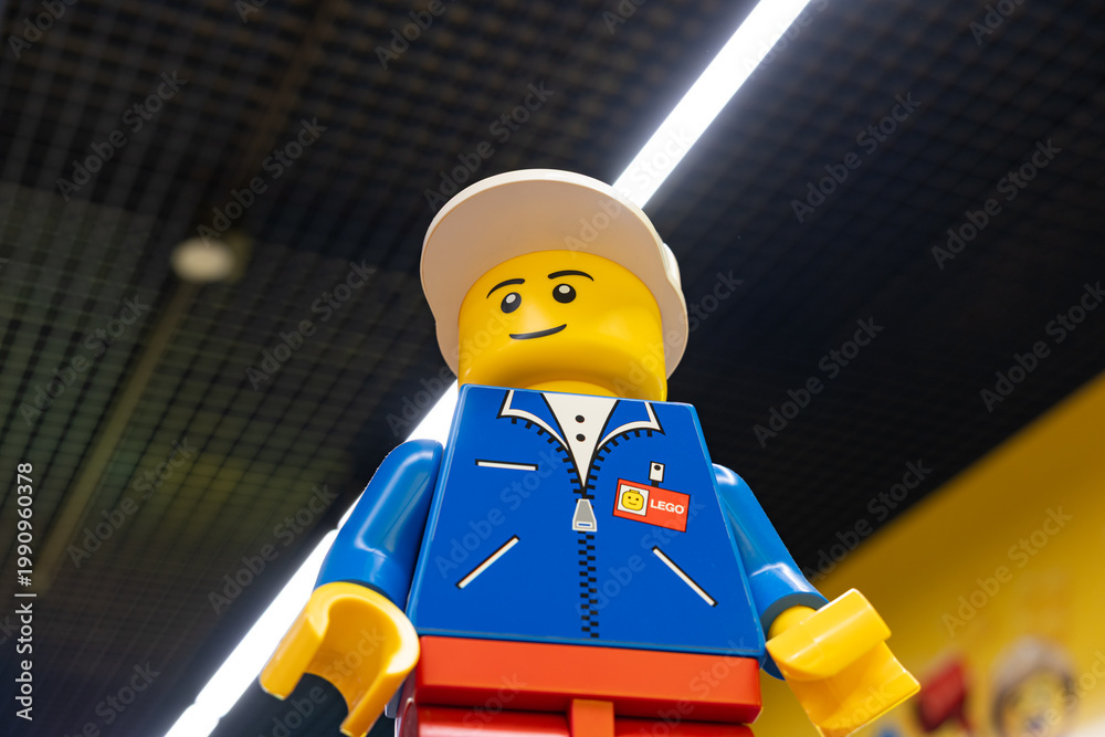 Fototapeta premium LEGO worker minifigure on yellow display shelf in store