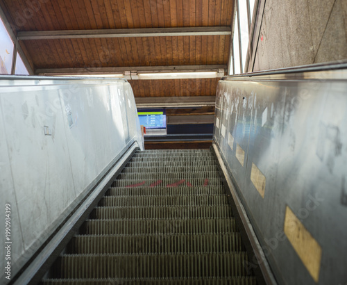 фотографія Abandoned escalator in a wooden clad station building with worn metal steps
