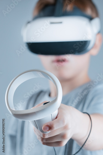 A gamer wearing virtual reality glasses with controllers and a headset