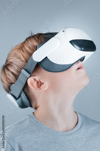 A boy enthusiastically explores the virtual world in a VR helmet