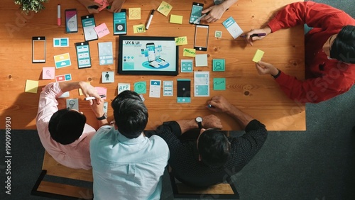 Konstfotografi Programmer sharing Ux Ui design for mobile phone interface idea with software developer while designer writing idea at sticky notes
