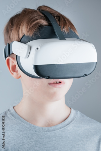 A boy enthusiastically explores the virtual world in a VR helmet