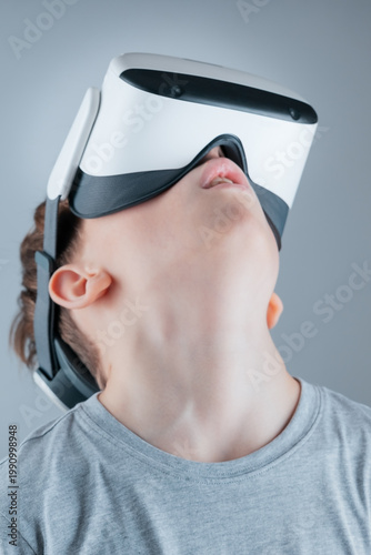 A boy enthusiastically explores the virtual world in a VR helmet