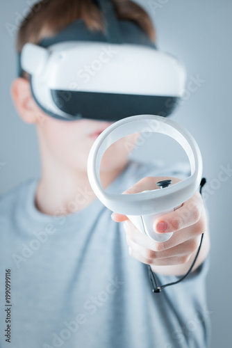 A gamer wearing virtual reality glasses with controllers and a headset