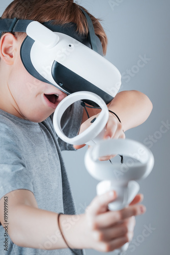 A gamer wearing virtual reality glasses with controllers and a headset