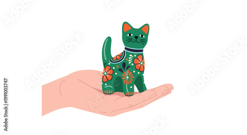 A human hand gently supports a small green alebrije cat figurine adorned with intricate orange floral patterns in a bright studio with a white background.