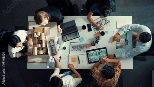 Fotografía Architect team discussing and pointing and presenting blueprint to interior designer