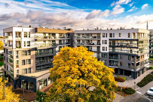 New modern residential block buildings and autumn park. Housing development in Europe