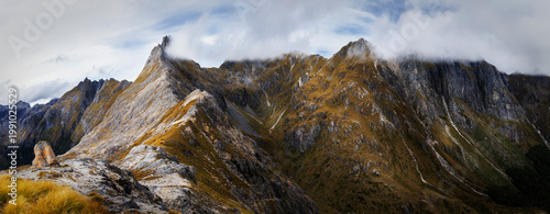Jagged Mountain Peaks Under Low Clouds in Fiordland