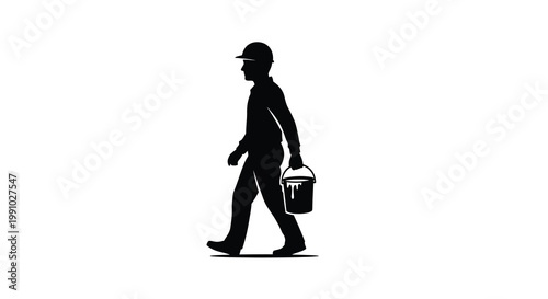 Silhouette of a worker carrying a paint bucket while walking