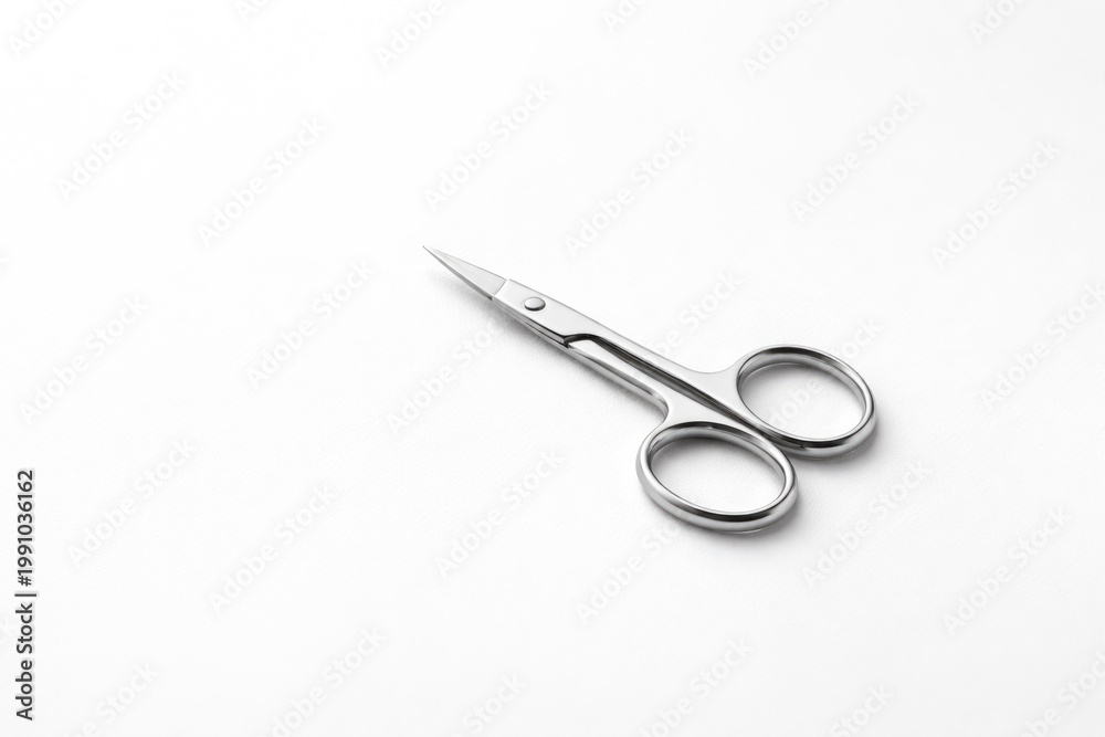 Obraz premium Tiny manicure scissors showcased against a bright white surface with extensive copy space