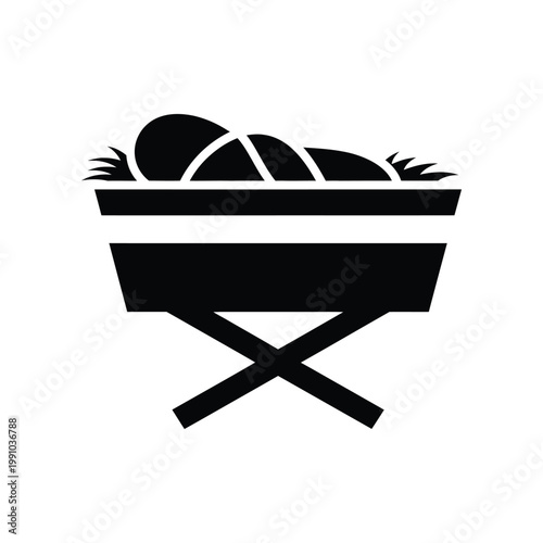 Stylized black icon of baby in manger with hay representing Christmas nativity scene for seasonal holiday graphic design and creative web projects on white background