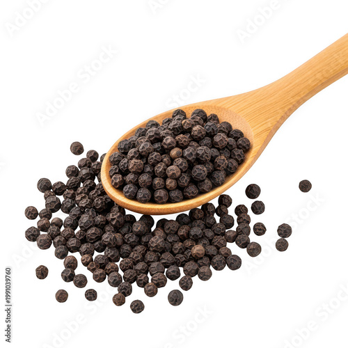 Scoop of black peppercorns on a wooden spoon