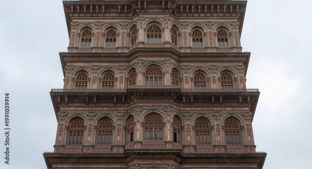 Obraz premium Tall multi level building showcasing intricate architectural window elements