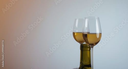 Two white wine glasses topp...