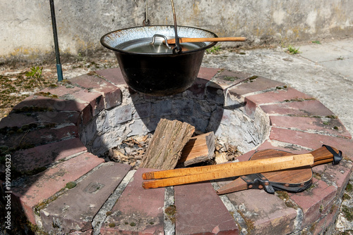 built-in fireplace in garden with cauldron and cooking utensils
