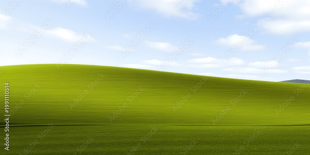 Obraz premium A serene green hill under a blue sky with white clouds on a sunny day in a natural landscape