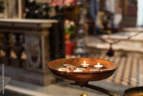 Votive candles burning inside the church of San Gennaro Naples ,  Italy.