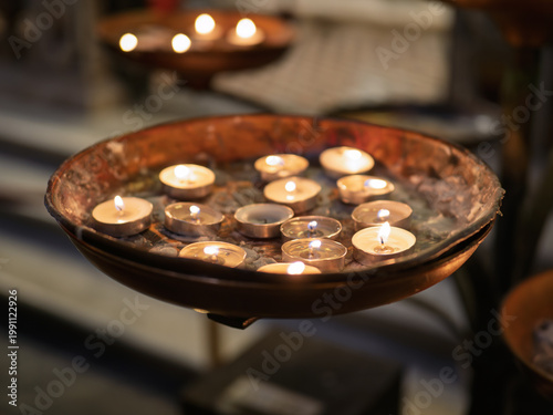 Votive candles burning inside the church of San Gennaro Naples ,  Italy.