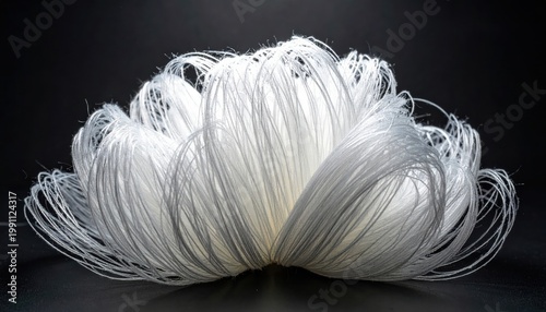 Intricate arrangement of delicate white superconductive material threads showcasing complex topology