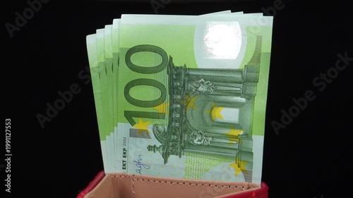 Hundreds of Euro banknotes in wallet showing substantial wealth and financial stability