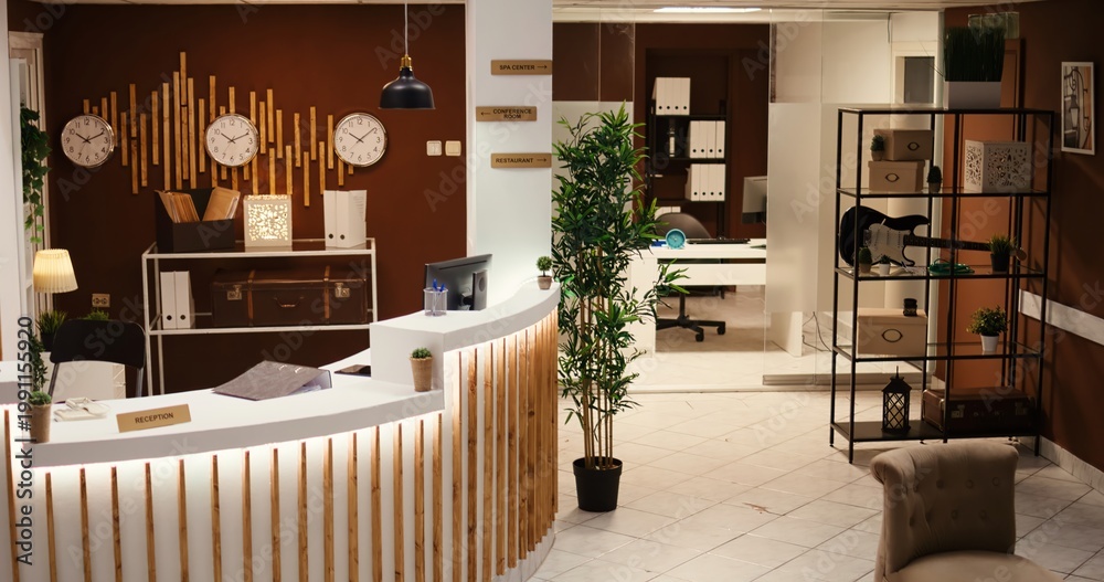 Obraz premium Crane down shot of empty travel accommodation resort stylish lounge interior with cozy furniture and warm fireplace ready to welcome tourists. Modern hotel lobby with check in front reception desk