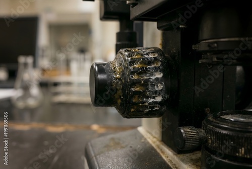 Close-up of microscope dial indent with thick buildup of finger grime and sanitizer scale
