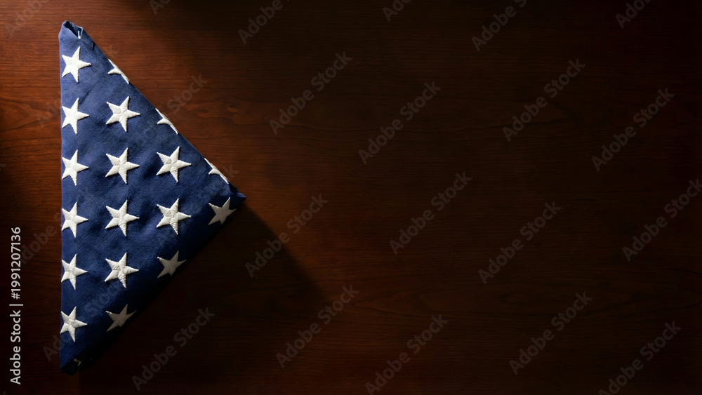 Obraz premium Triangular USA Flag Fold on Wooden Surface for Memorial Day Tribute