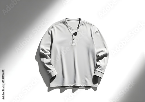 Isolated light grey henley long sleeve shirt with button placket on soft shadows, apparel photography for catalog