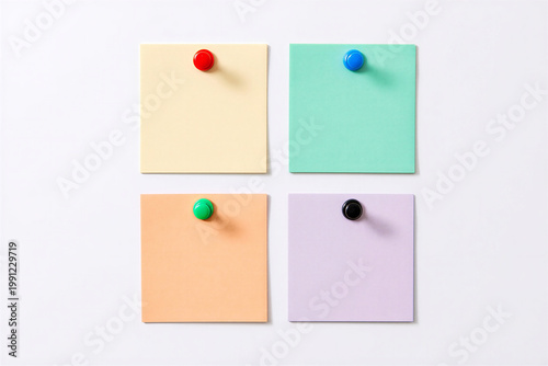 Four Pastel Sticky Notes Pinned on a White Background, Top View