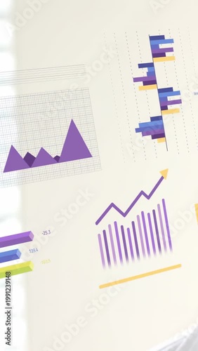 Vertical video: Camera panning across business wall, revealing data rings and bar charts for review