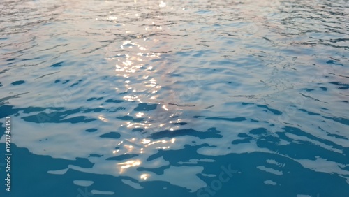 Sunlight Reflection on Calm Blue Water Surface Creating Sparkling Natural Background