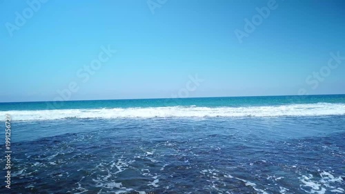 Powerful Ocean Waves Breaking on Open Blue Sea with Clear Sky and Clean Horizon - 4K Footage