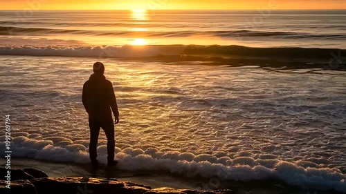 Man Standing on Beach at Sunset.