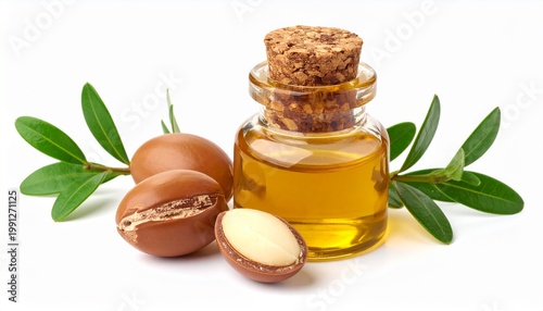 Argan nuts with small glass bottle containing oil and fresh leaves, isolated white background, luxury natural cosmetics concept, high resolution.