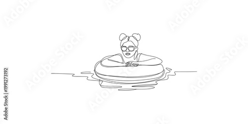 A woman wearing goggles and floating on an inflatable tube in water