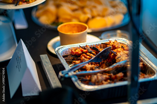 Canvas-taulu Hot buffet food tray with serving tongs at catered event or hospitality banquet